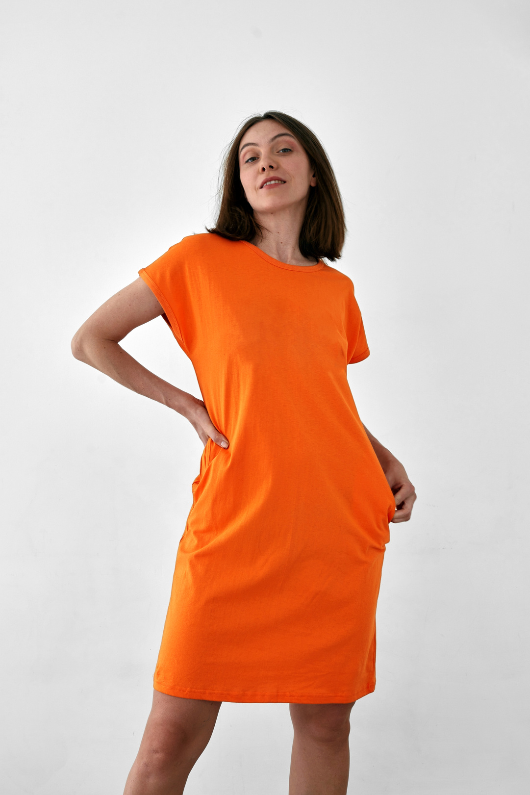 Pretty Woman in Orange Dress White Background